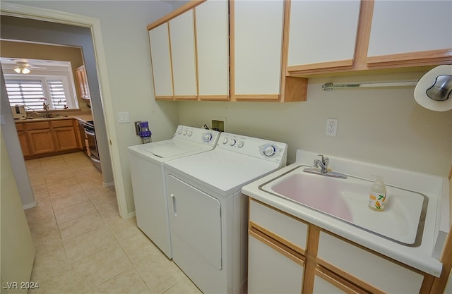 laundry area featuring ceiling fan, separate washer and dryer, sink, light tile patterned flooring, and cabinets