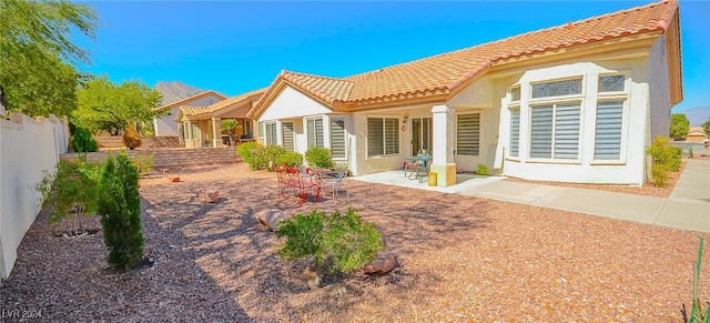 back of property with a patio