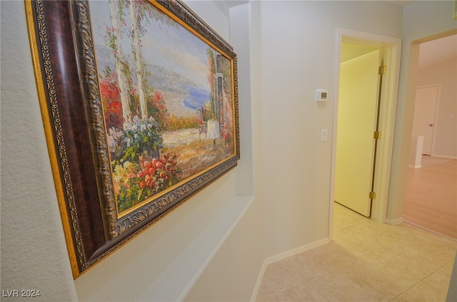 hall featuring light tile patterned floors