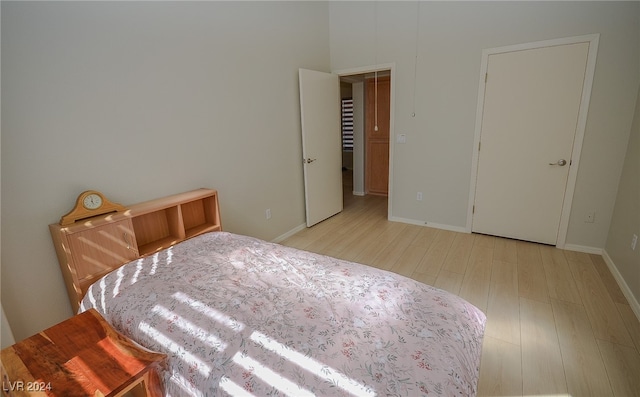 bedroom with light wood-type flooring and a closet