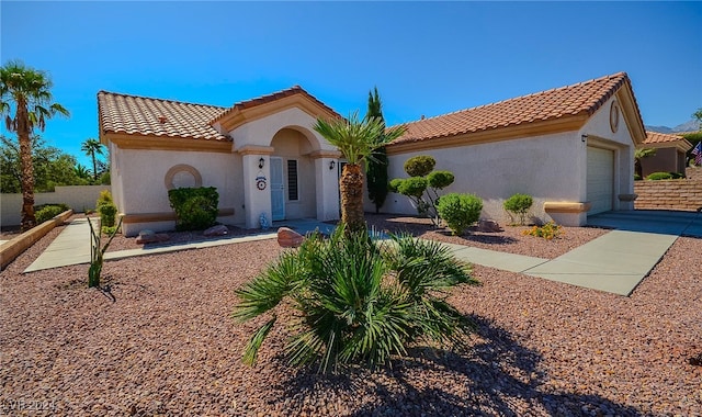 mediterranean / spanish-style home with a garage