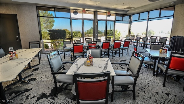 dining space featuring carpet flooring and a wealth of natural light