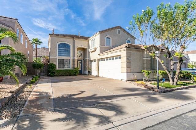 mediterranean / spanish-style home with a garage