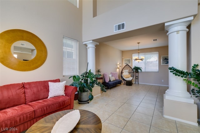 living room with a notable chandelier, a healthy amount of sunlight, and light tile patterned floors