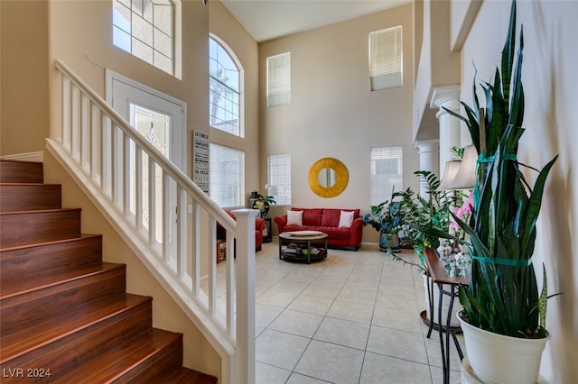 interior space with a high ceiling and tile patterned floors