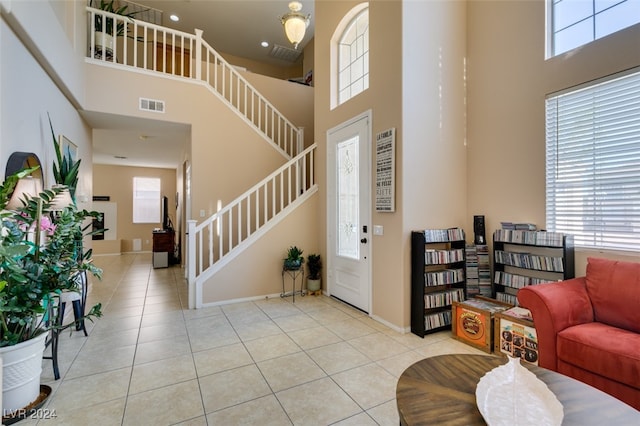 tiled foyer with a high ceiling