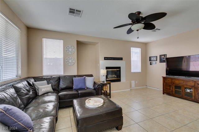 tiled living room featuring ceiling fan