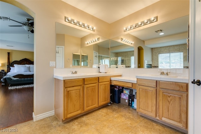 bathroom with vanity, hardwood / wood-style flooring, a shower with shower door, and ceiling fan