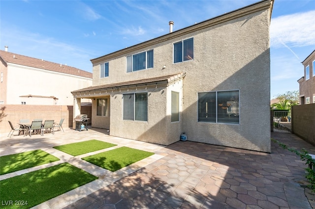 rear view of property featuring a patio area