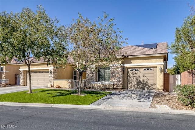 view of front of property with solar panels, a front lawn, and a garage