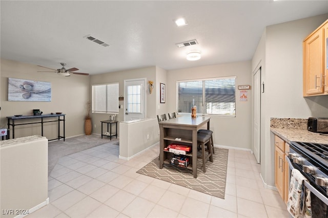 dining area with ceiling fan and light tile patterned floors