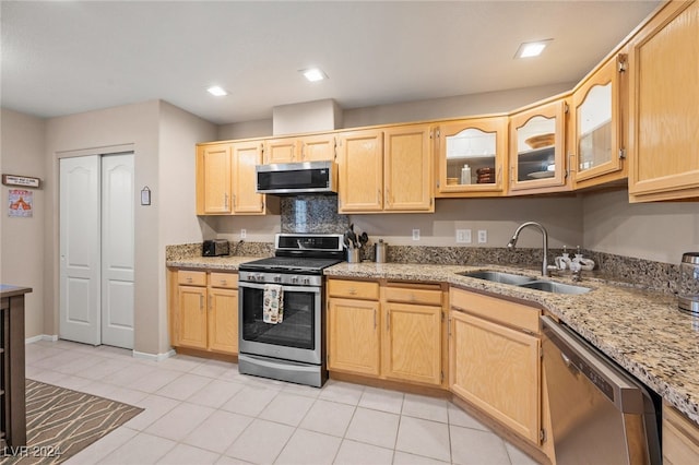 kitchen featuring light brown cabinetry, appliances with stainless steel finishes, sink, and light tile patterned floors