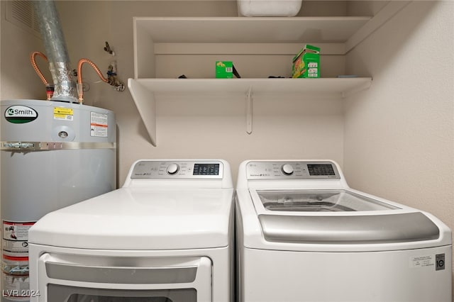 laundry room with water heater and independent washer and dryer