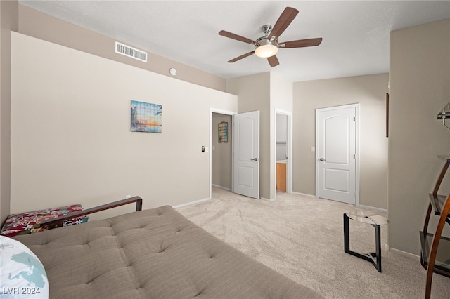 bedroom featuring light colored carpet and ceiling fan