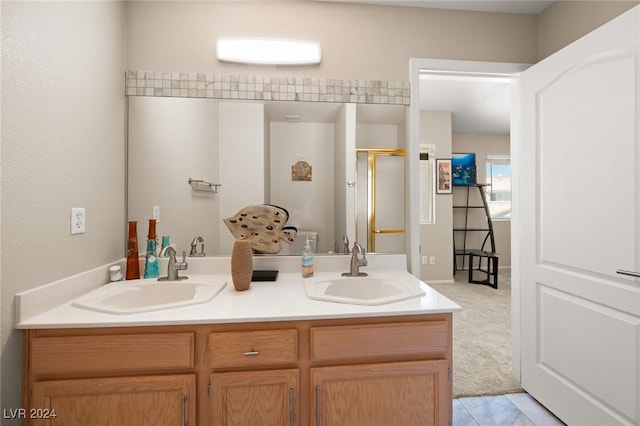 bathroom featuring tile patterned flooring, a shower with door, and vanity