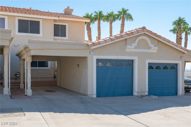 view of front of home featuring a garage and a carport