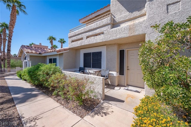 doorway to property with a patio area