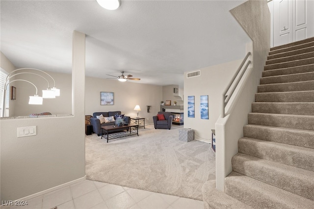 carpeted living room featuring ceiling fan