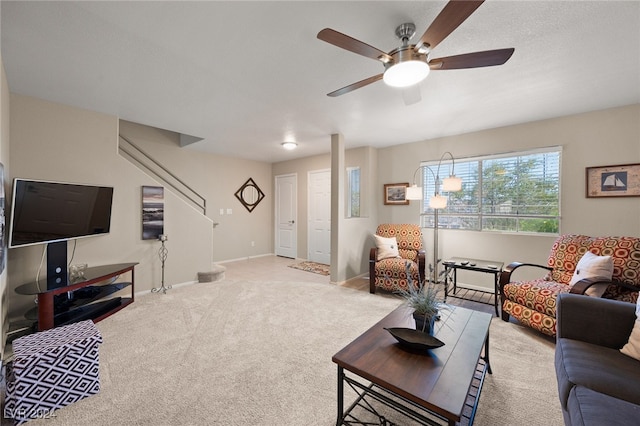 carpeted living room featuring ceiling fan