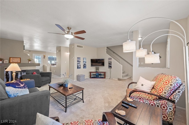 carpeted living room with ceiling fan