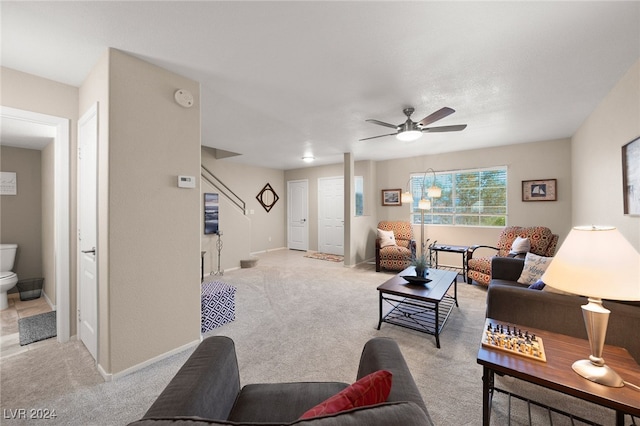 carpeted living room with ceiling fan