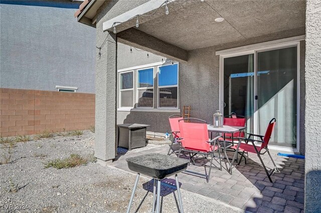 view of patio featuring outdoor dining area and fence