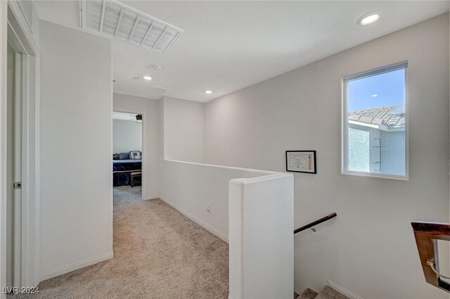 hallway featuring baseboards, recessed lighting, an upstairs landing, visible vents, and carpet