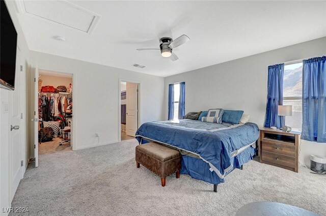 bedroom with carpet floors, multiple windows, attic access, and visible vents