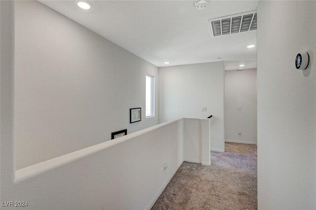 hall with carpet, visible vents, recessed lighting, an upstairs landing, and baseboards