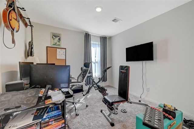carpeted office space featuring baseboards and visible vents