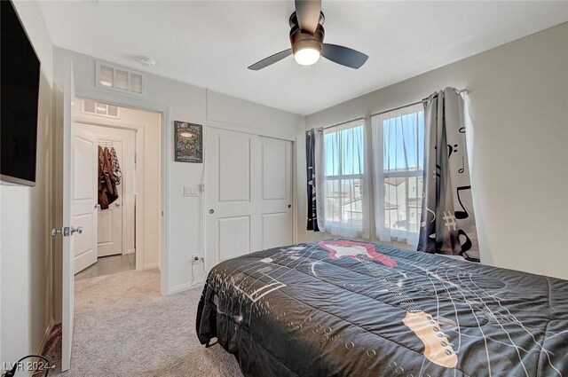 bedroom featuring visible vents, a closet, a ceiling fan, and carpet floors