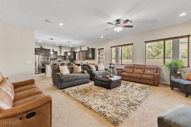 carpeted living room with ceiling fan