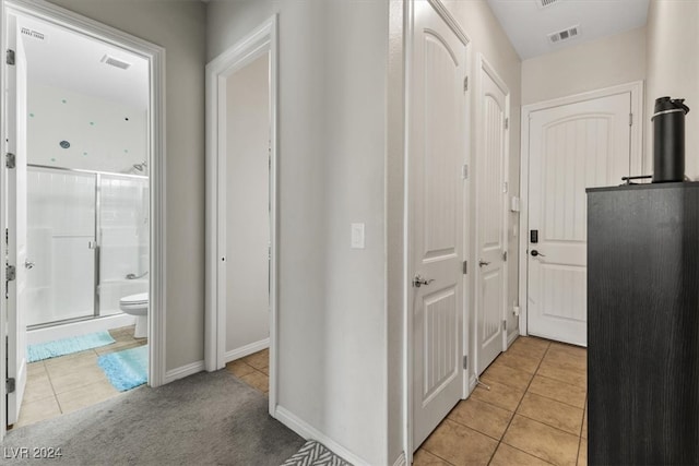 hall featuring light tile patterned flooring