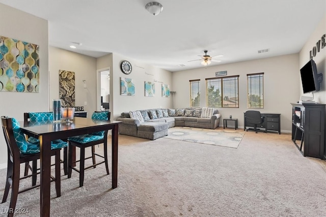 living room featuring carpet floors and ceiling fan