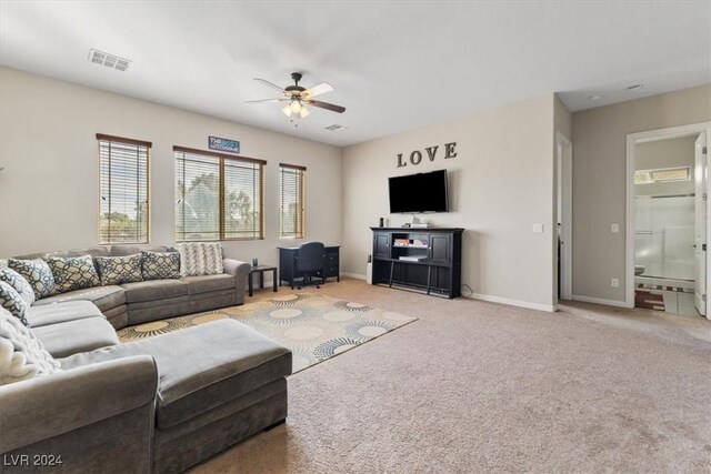 living room with light colored carpet and ceiling fan