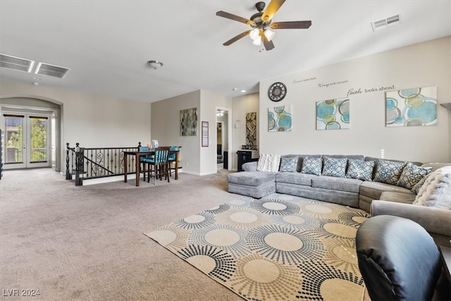 living room featuring light colored carpet and ceiling fan