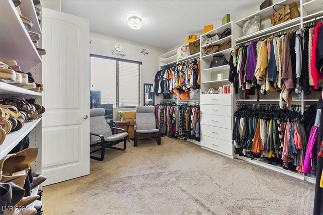 walk in closet featuring light colored carpet