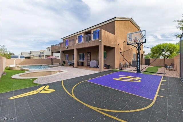 view of basketball court with a fenced in pool