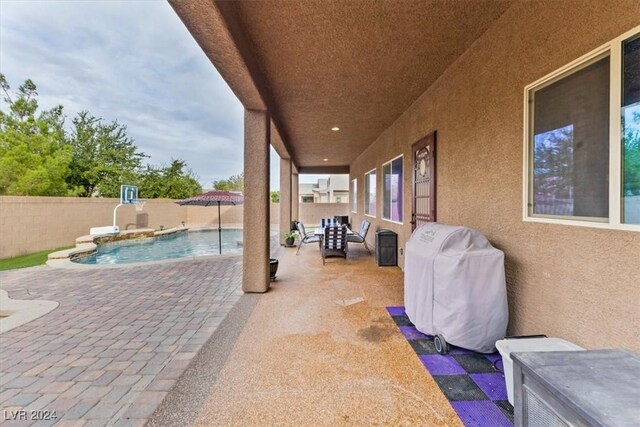 view of patio with a fenced in pool and a grill