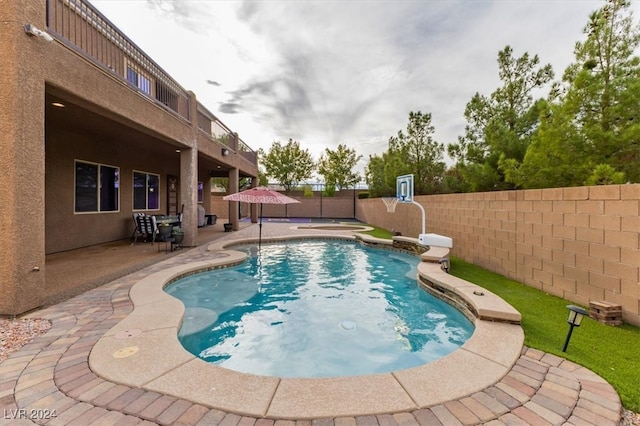 view of swimming pool with a patio area