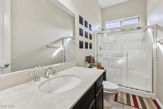 bathroom featuring tile patterned flooring, vanity, walk in shower, and toilet