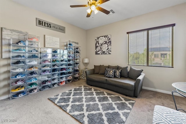 carpeted living room with ceiling fan