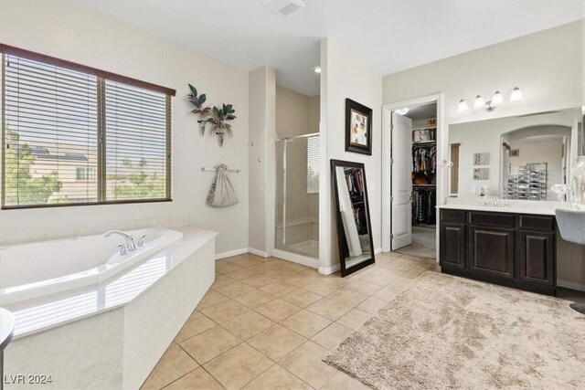 bathroom featuring vanity, shower with separate bathtub, and tile patterned flooring