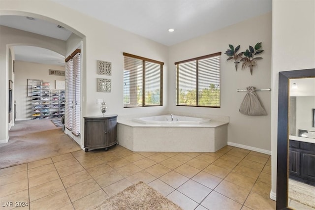 bathroom with vanity, tile patterned flooring, and a washtub