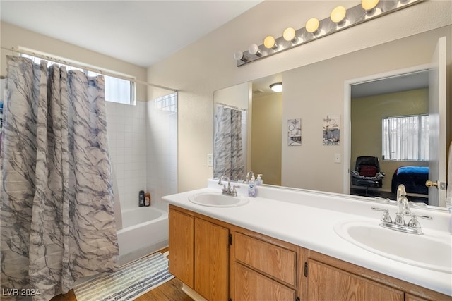 bathroom with wood-type flooring, shower / tub combo, and vanity