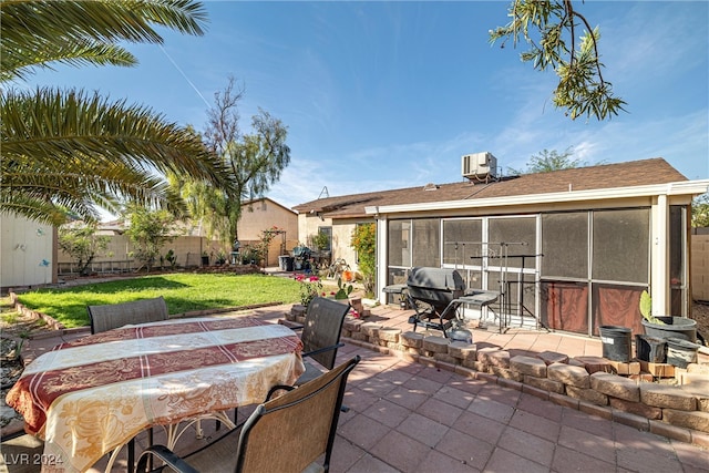 view of patio / terrace featuring a sunroom and central AC