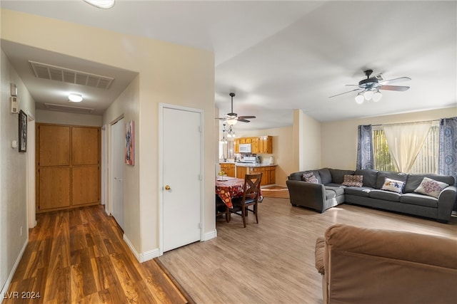 living room with hardwood / wood-style flooring and ceiling fan