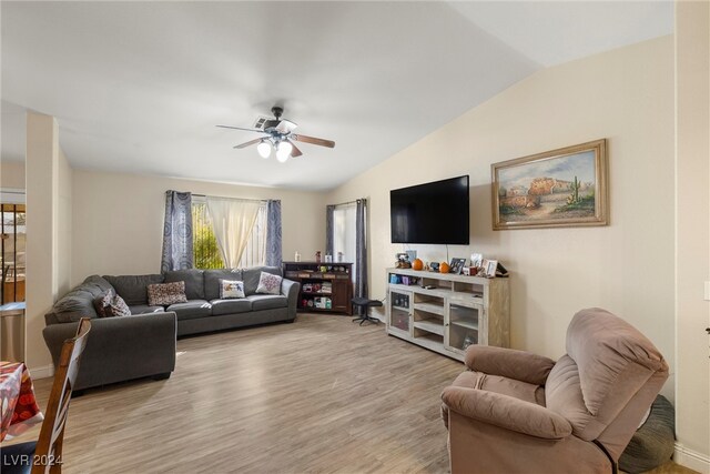 living room with ceiling fan, lofted ceiling, and light hardwood / wood-style floors