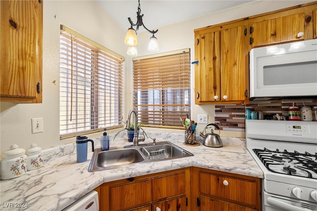 kitchen featuring decorative backsplash, white appliances, sink, hanging light fixtures, and an inviting chandelier