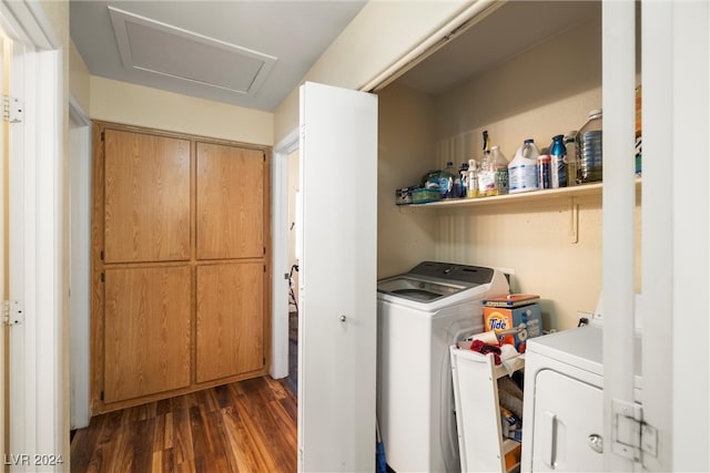 clothes washing area with independent washer and dryer and dark hardwood / wood-style flooring